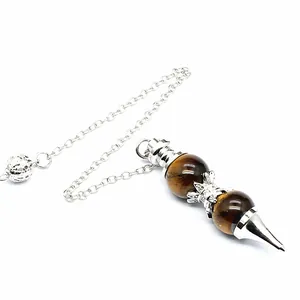 Detail view of a Tiger's Eye stone pendulum with silver chain and 12mm round beads