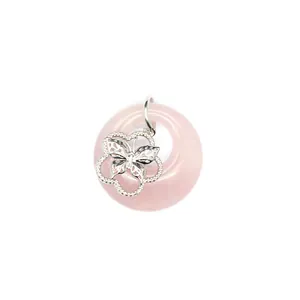 Gros plan d'un pendentif donut en quartz rose avec une breloque papillon argentée