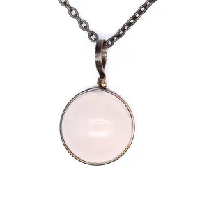 Detailed close-up view of vintage rose quartz stone pendant necklace with metallic chain