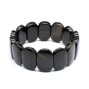 Close-up of natural black stone bracelet with oval tiles and subtle golden flash