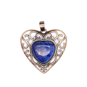 Detailed view of a vintage bronze heart pendant with blue natural lapis lazuli