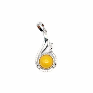 Macro view of silver-toned pendant featuring a round yellow aventurine stone and crystals