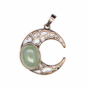 Antique hollowed-out crescent moon pendant with oval green natural gemstone detail