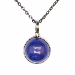 Detailed view of vintage blue lapis lazuli round stone pendant with bronze wire wrapping