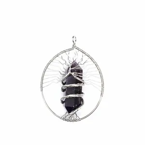 Detail of handmade wire-wrapped tree of life pendant with amethyst hexagonal column crystal
