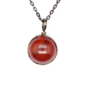 Close-up of vintage red agate pendant necklace with bronze wire wrapping detail