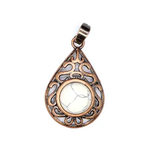 Detailed view of vintage hollow teardrop pendant with a white turquoise stone inlay