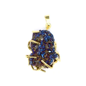 Macro detail view of gold wire wrapped pendant with iridescent blue druzy stone