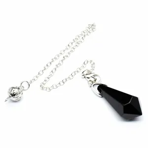 Macro view of a hexagonal black stone pendulum pendant with a silver chain decoration