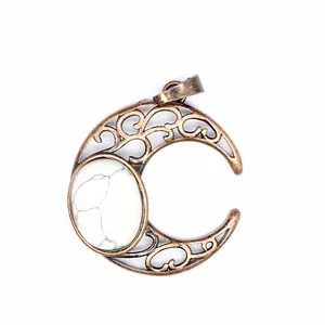 Detailed macro shot of an antique crescent moon pendant with white marble stone.