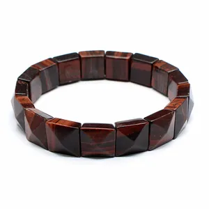 Close-up of faceted square red tiger eye stone beads on a durable stretch bracelet.