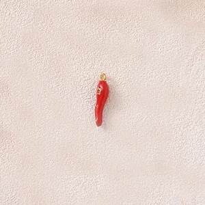 Detail view of a 3D red chili pendant made of gold-plated stainless steel for jewelry