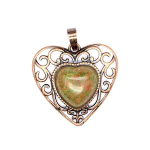 Detail view of the vintage heart pendant featuring a natural unakite stone insert.