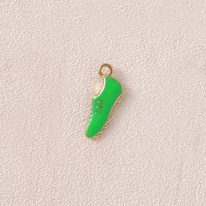 Detailed close-up of a green soccer boot charm with gold-colored trim for DIY jewelry making