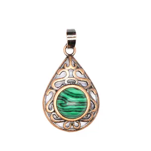 Detailed view of teardrop pendant featuring bronze filigree and green malachite stone