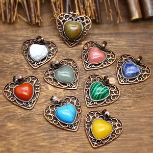 Assortment of vintage heart pendants featuring varied natural stones in filigree frames
