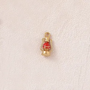 Detailed macro shot of a gold-plated 3D miniature lantern charm for custom jewelry DIY