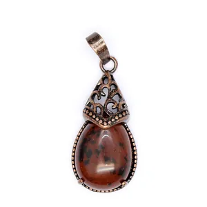Detailed view of teardrop mahogany obsidian pendant in vintage bronze filigree setting