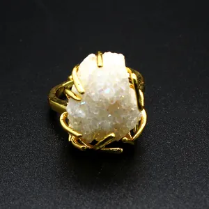 Macro detail of natural white agate druzy crystal cluster in gold plated wire setting