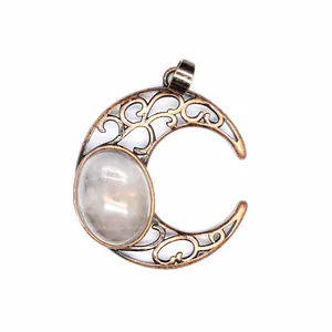 Detail view of antique moon pendant with hollow filigree and natural crystal stone inlay.