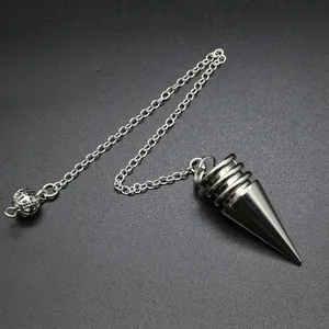 Detailweergave van een kegelvormige metalen pendel met zilverkleurige ketting en bol