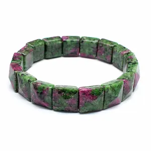 Close-up of faceted square ruby in zoisite stone bead bracelet on white background