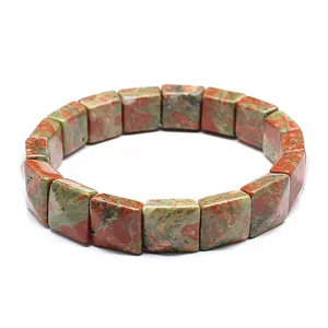 Macro shot of natural green and red Unakite stone square beads on a stretch bracelet
