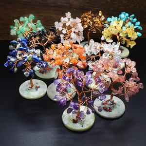 Collection of various handmade wire-wrapped gemstone chakra trees on stone bases