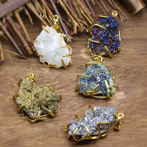 Macro view of colorful natural druzy agate crystal cluster pendants in gold wire wrap settings