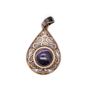 Macro view of teardrop hollow metal pendant with round purple natural stone