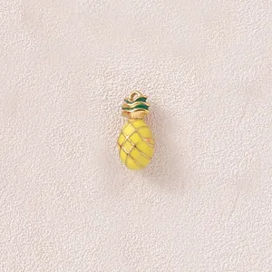 Close-up of a 3D gold-plated pineapple pendant with yellow and green enamel finish