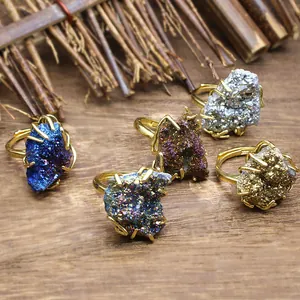 Detail view of five electroplated natural druzy agate rings in various vibrant colors