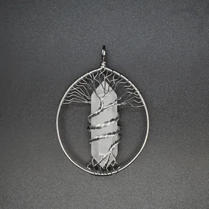 Detailed close-up of wire-wrapped tree of life pendant with clear crystal pillar