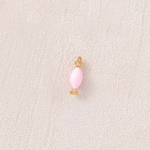 Close-up detail view of a pink candy shaped pendant with a polished gold finish