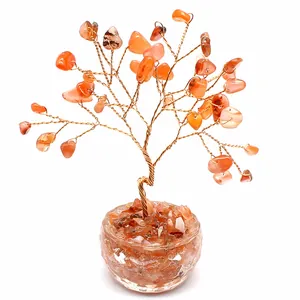 Detailed view of carnelian crystal money tree with gold wire branches and glass base