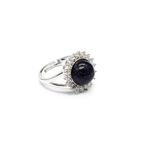 Detailed close-up of an adjustable silver ring featuring blue sandstone and crystal halo