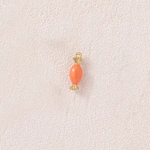 Detailed view of a gold-plated stainless steel candy charm with coral orange finish
