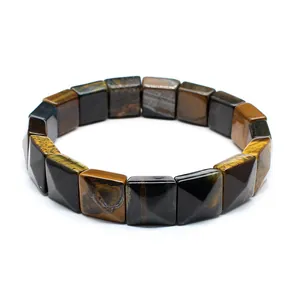 Detail view of natural tiger eye stone bracelet with faceted square beads on white background