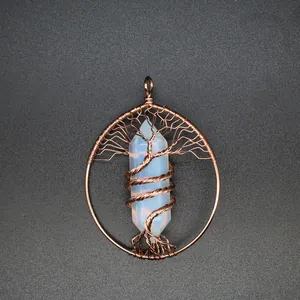 Detailed close-up of handmade copper wire tree of life pendant with opalite crystal point