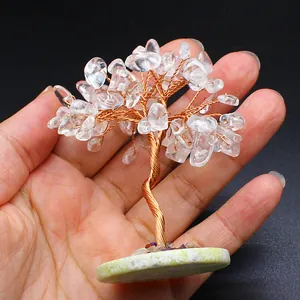 Hand-held mini wire wrapped tree ornament with clear crystal leaves on a calcite base