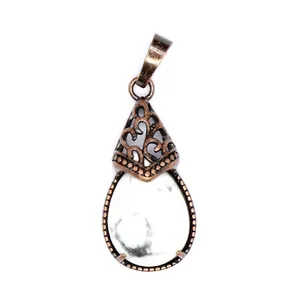 Detailed view of retro waterdrop pendant with white marbled stone and copper filigree.