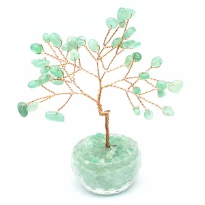Close-up of a green natural stone crystal tree of life with copper wire branches