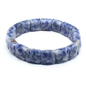 Detailed macro shot of natural blue and white square stone beads on a beaded bracelet