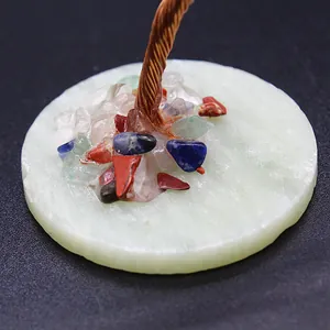 Close-up detail of mini calcite base with chakra crystal stones and copper wire tree trunk