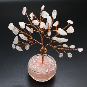 Detailed shot of rose quartz crystal tree of life on copper wire with black background