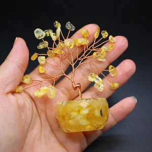 Mini handmade yellow crystal money tree with copper wire on palm for size reference