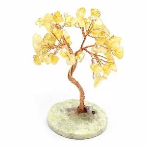 Handcrafted yellow crystal tree on a circular light green calcite stone base