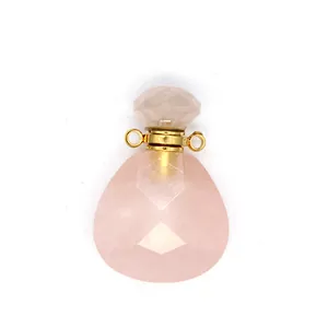 Detailed view of faceted pink natural stone perfume bottle pendant with gold accents