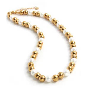 Close-up of a necklace featuring alternating gold steel beads and white pearls