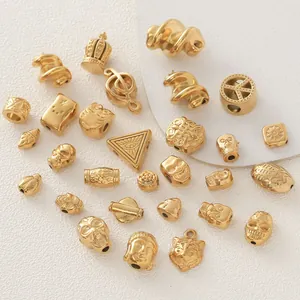 Close-up showing various gold-plated stainless steel charms for DIY jewelry making